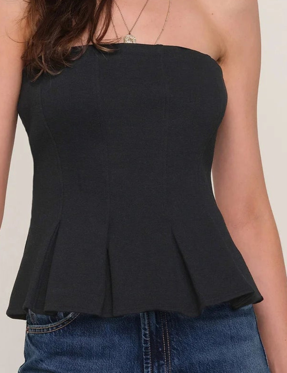 Close up  of  black pleaded at the bottom strapless top 