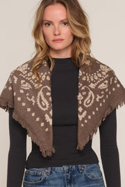 A woman wearing a brown and beige patterned knit shawl 