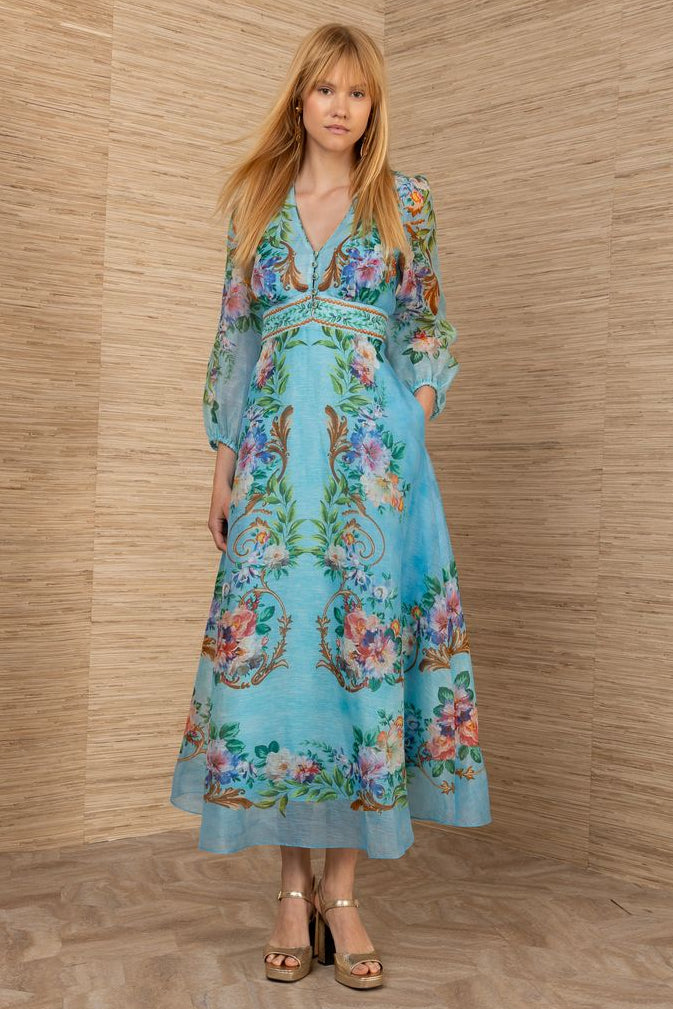 woman wearing a turquoise chiffon floral midi dress