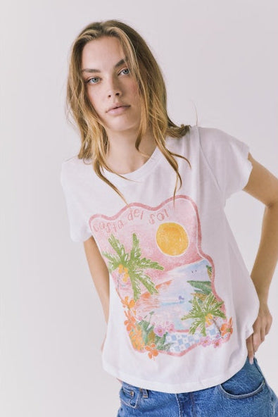 Woman wearing a white graphic tee shirt with a tropical graphic on the front