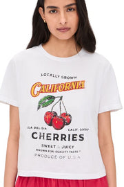Woman wearing a white tee with a California cherries graphic on the front