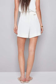 Back view of Woman wearing cream vegan silk shorts
