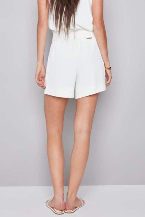 Back view of Woman wearing cream vegan silk shorts