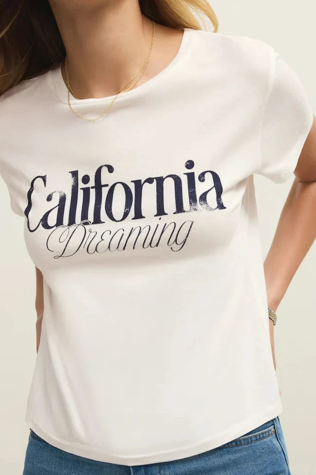 Close up of Woman wearing a white tee shirt with California dreaming graphic on front