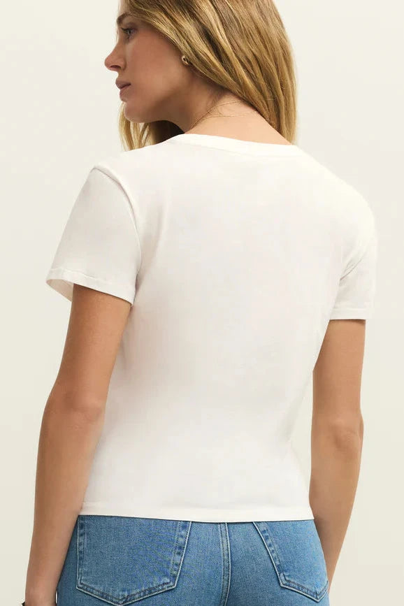 Back view of Woman wearing a white tee shirt with California dreaming graphic on front