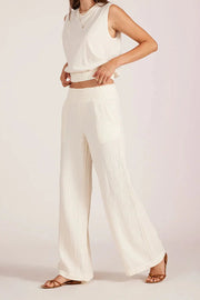 Woman wearing a wide leg beach pant in off white