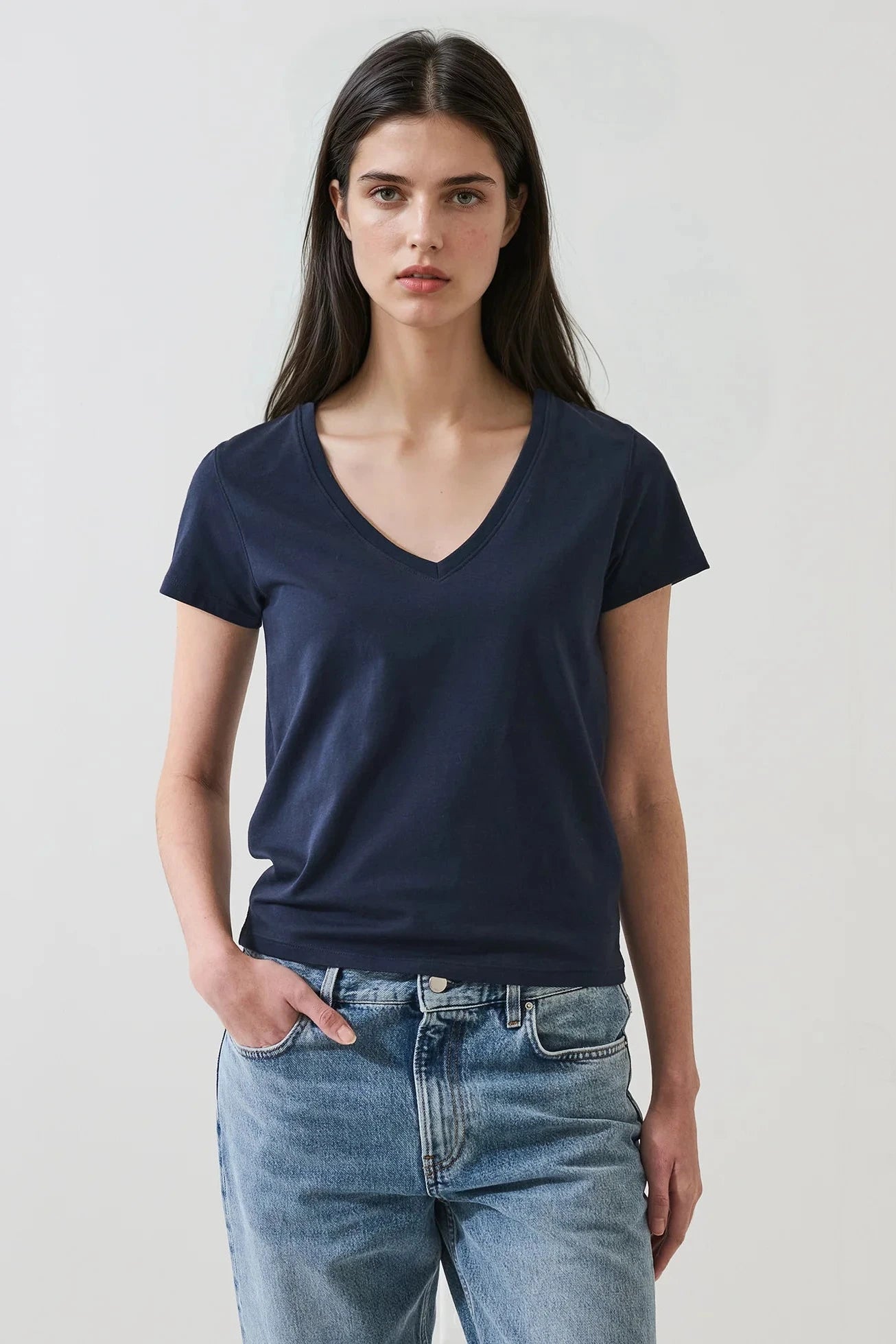 Woman wearing a dark navy blue v neck tee