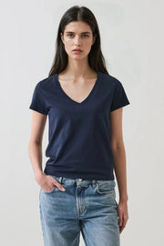 Woman wearing a dark navy blue v neck tee