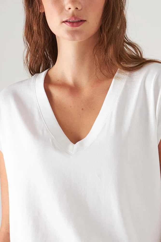 Close up of woman wearing a v neck shirt in white