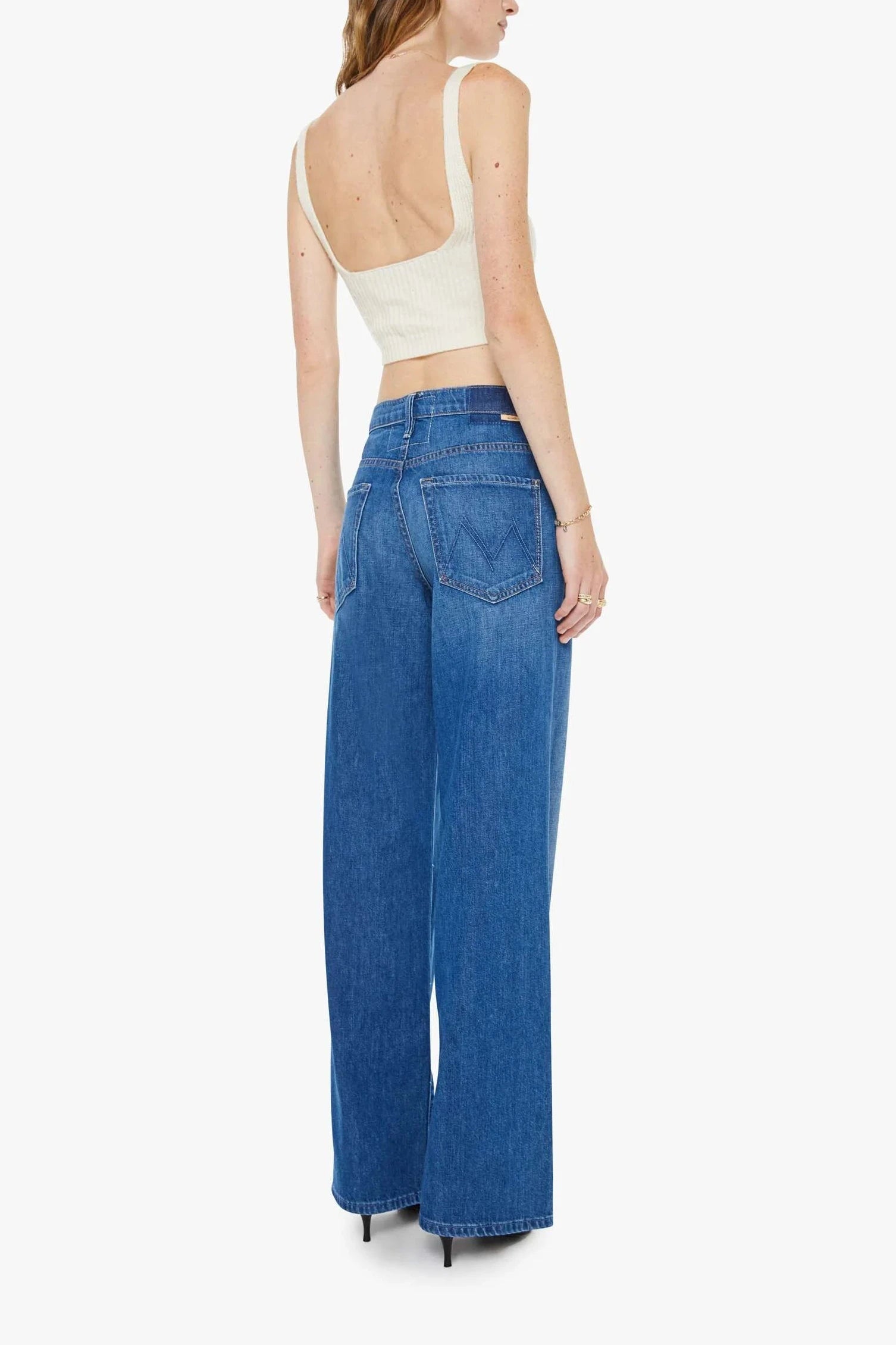 Woman wearing mid indigo wide leg jeans Back view