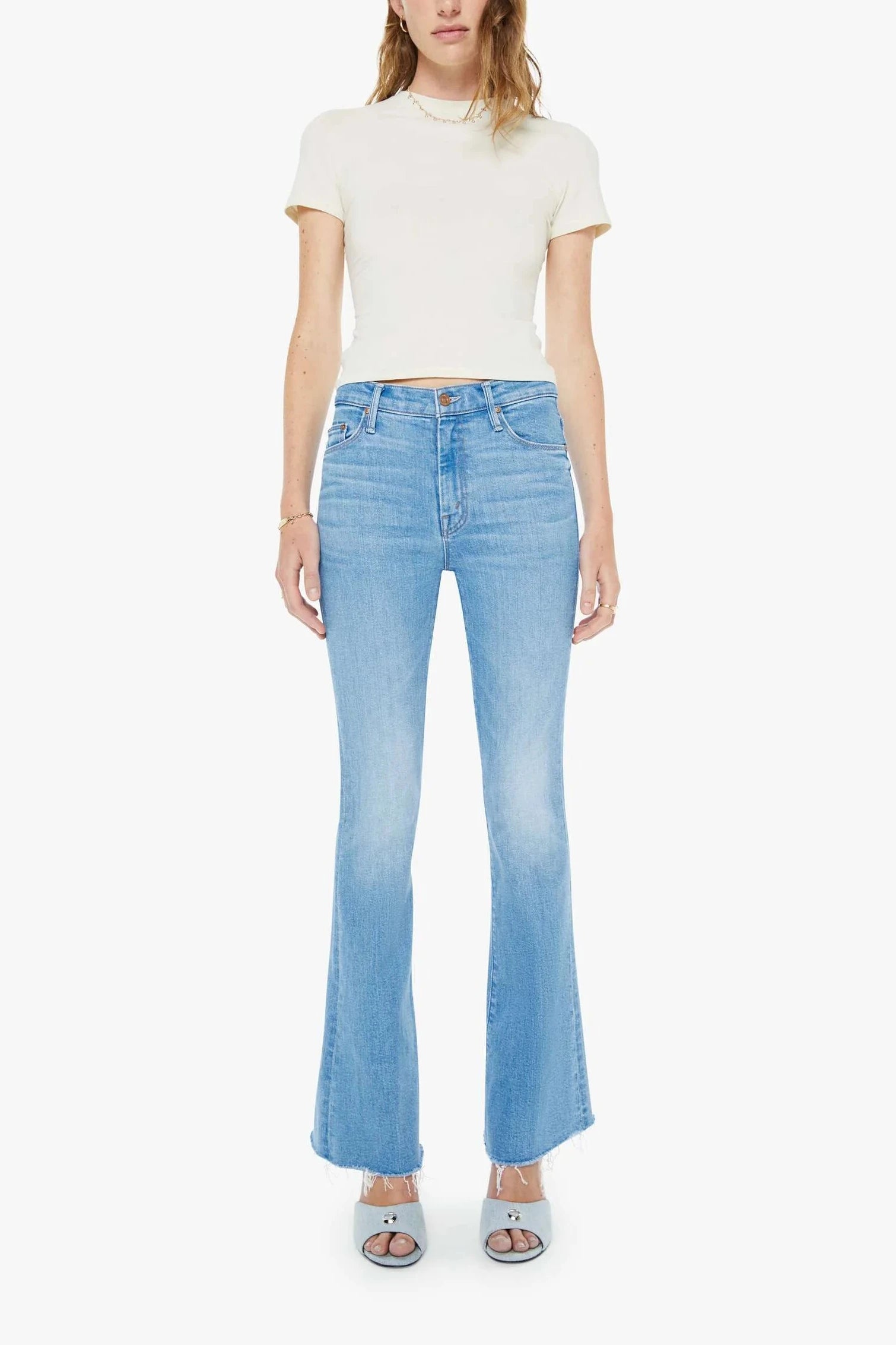 Woman wearing mid-light blue wash flare denim