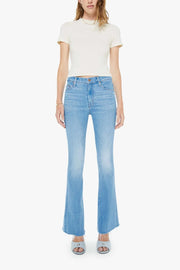 Woman wearing mid-light blue wash flare denim