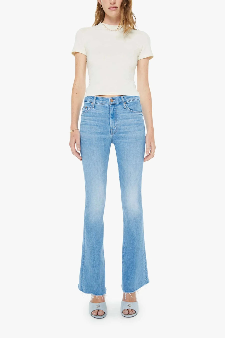 Woman wearing mid-light blue wash flare denim