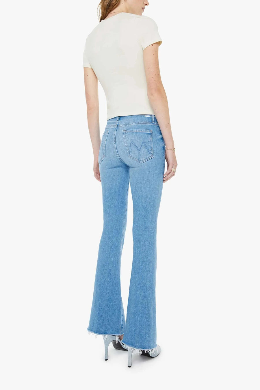 Back view of Woman wearing mid-light blue wash flare denim