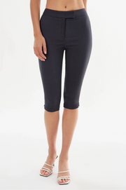 Woman wearing navy slim capri shorts