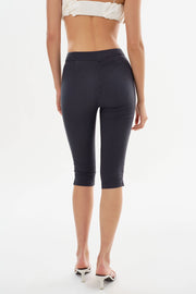 Backview of Woman wearing navy slim capri shorts