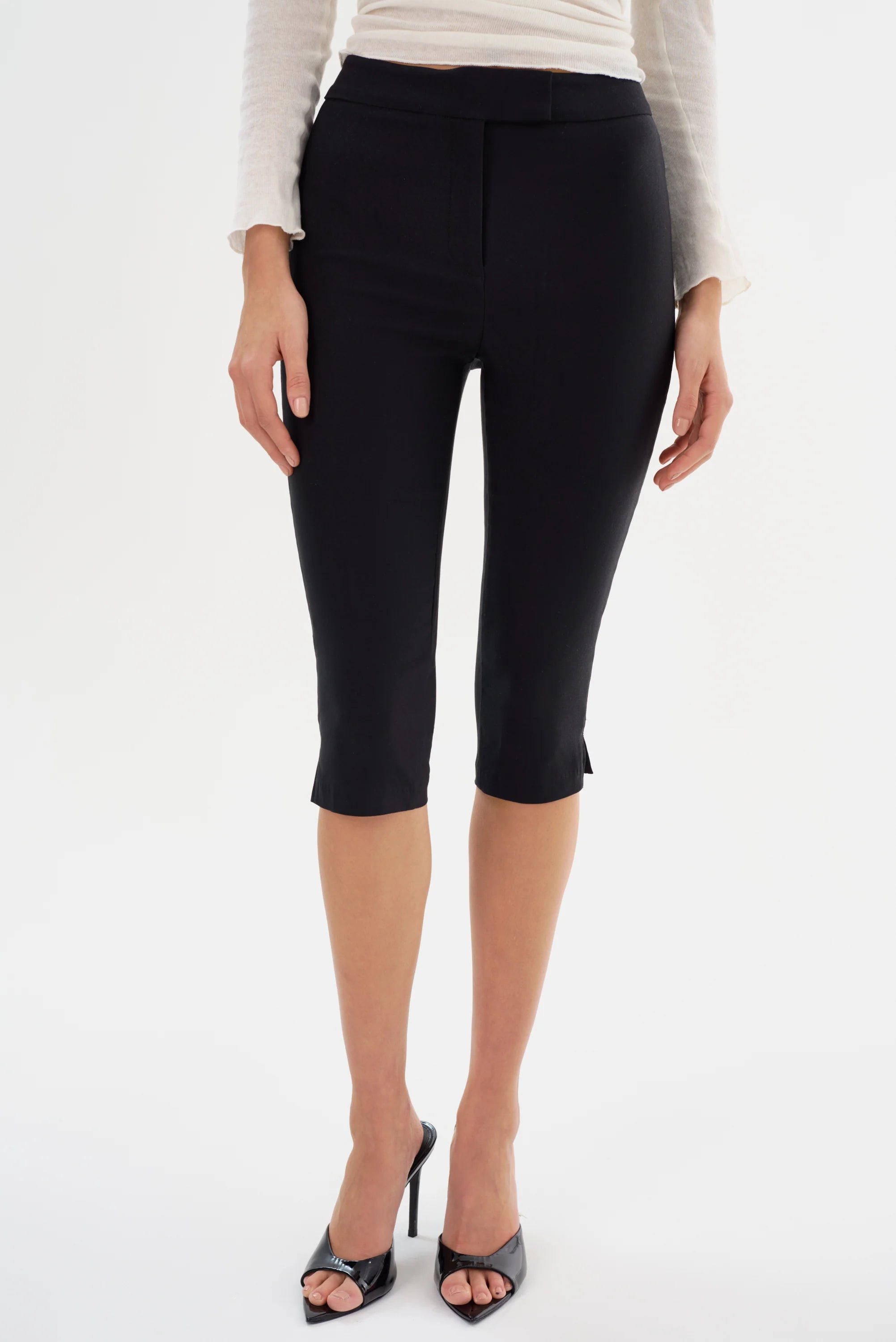 Woman wearing black slim capri shorts