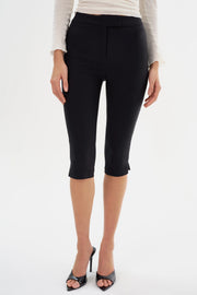 Woman wearing black slim capri shorts
