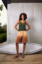 Woman wearing a dark green knit tank top