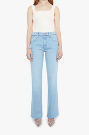 Woman wearing a light blue wash wide leg pair of denim