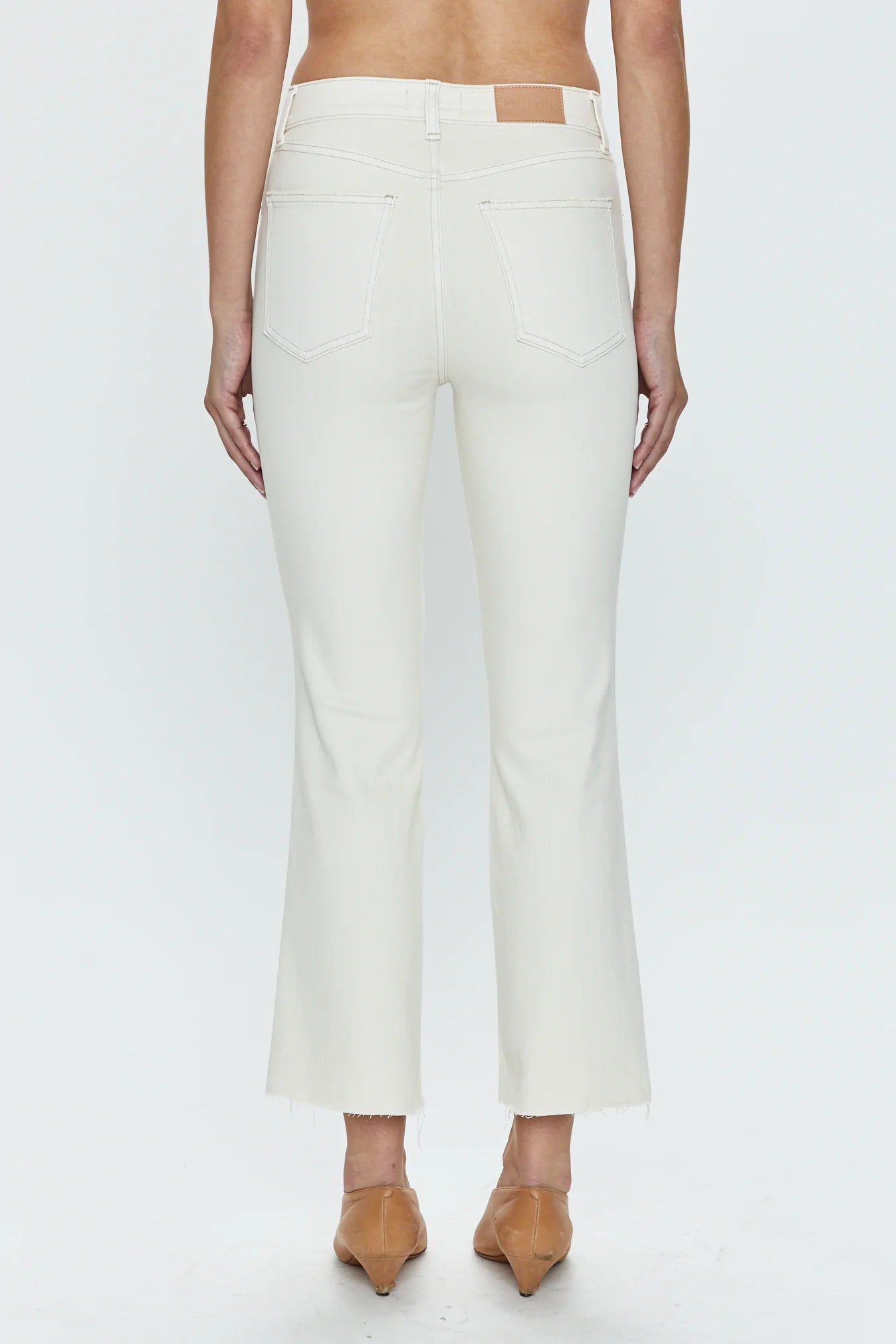 Back view of Woman wearing a pair of white cropped flare jeans