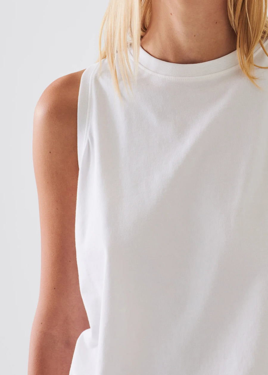 Close up of Woman wearing a white boyfriend fit tanktop