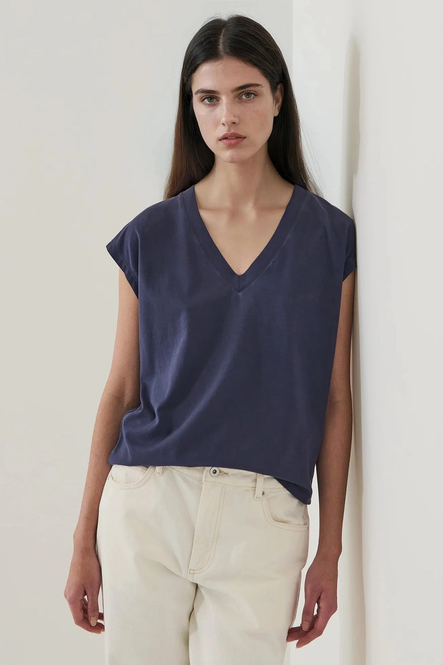 Woman wearing a navy blue long v neck tee shirt