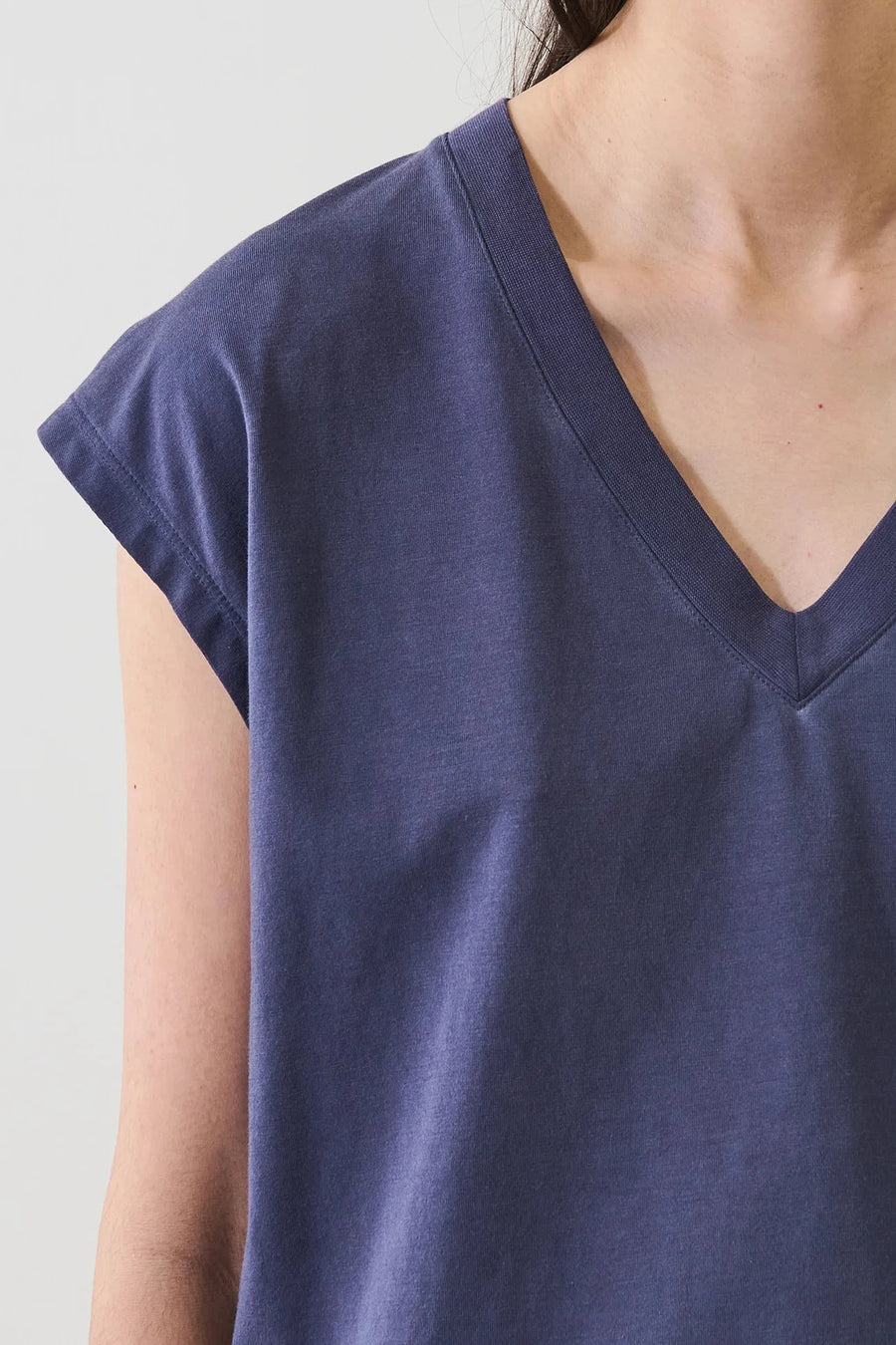 Close up of Woman wearing a navy blue long v neck tee shirt