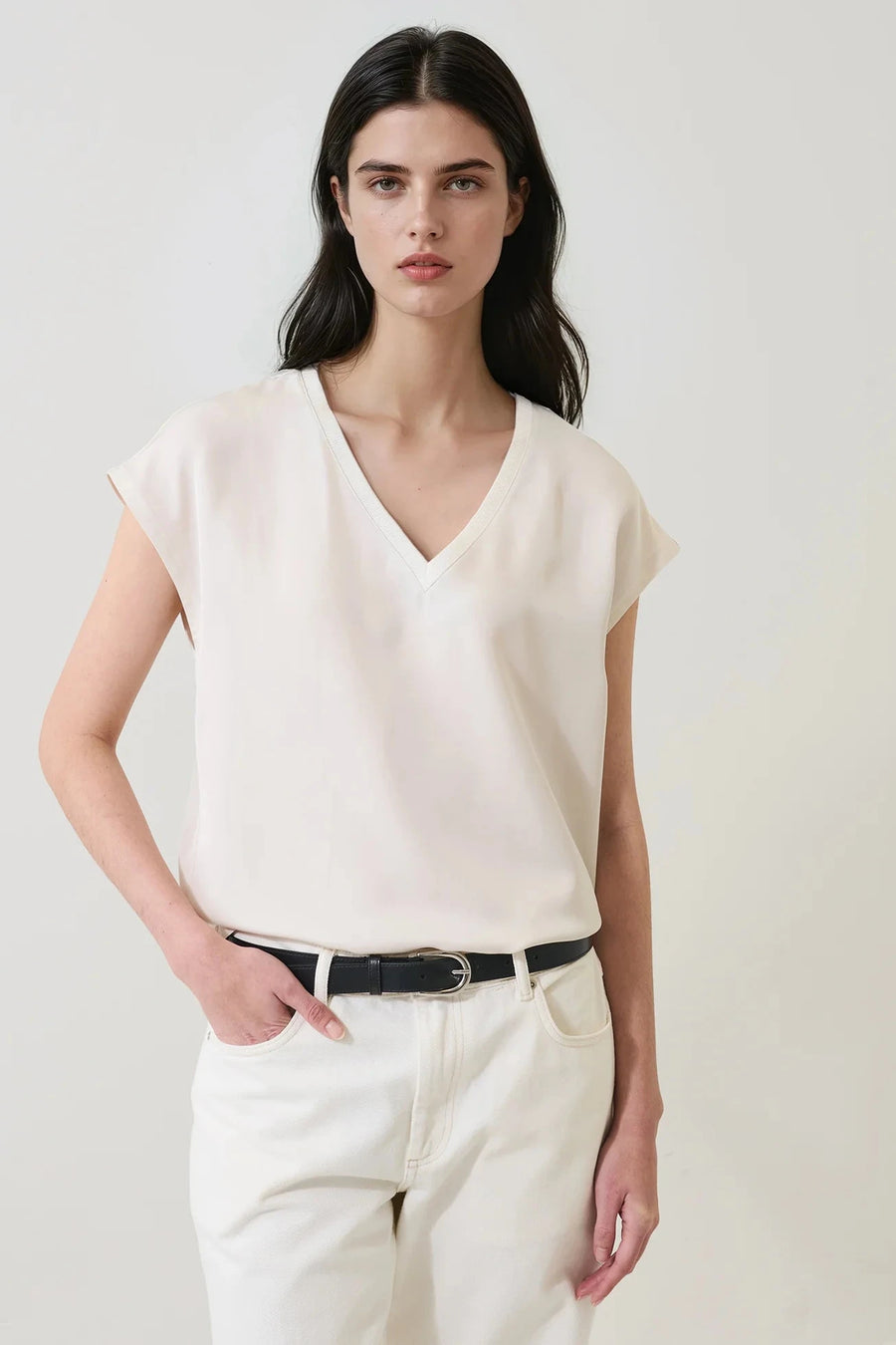 Woman wearing an off white v neck tee shirt