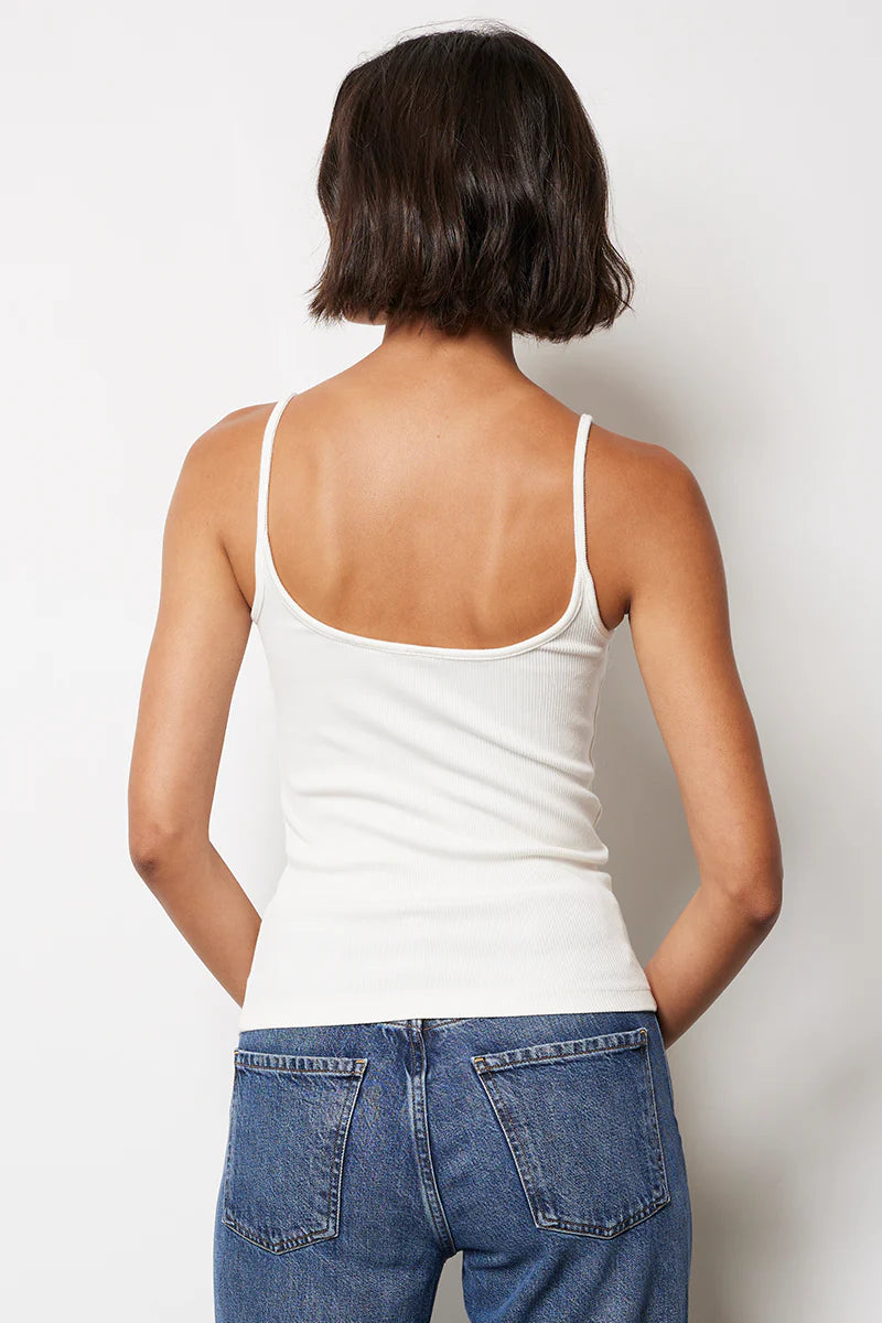 Back view of woman wearing a white tank top