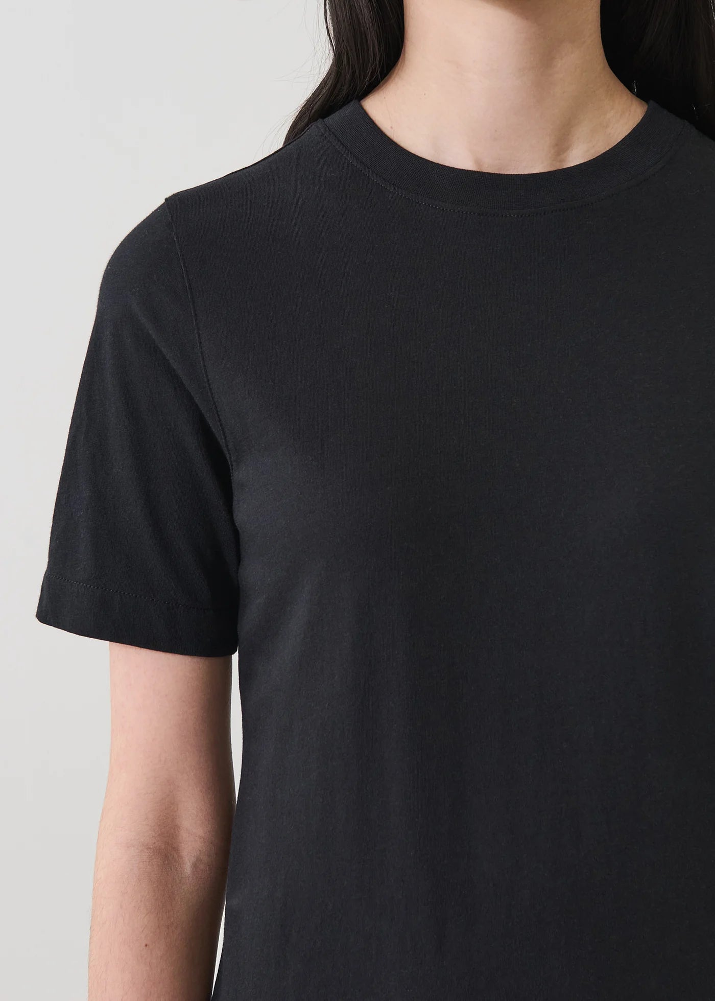 Close up of woman wearing a black tee shirt dress