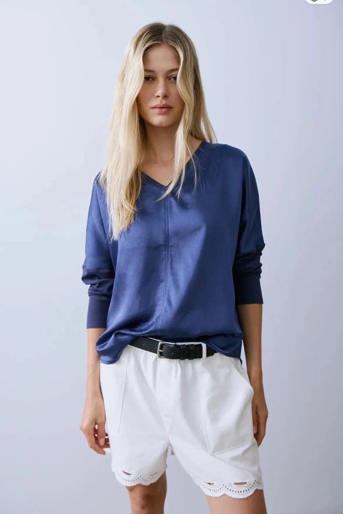 Woman wearing a satin long sleeve shirt in navy