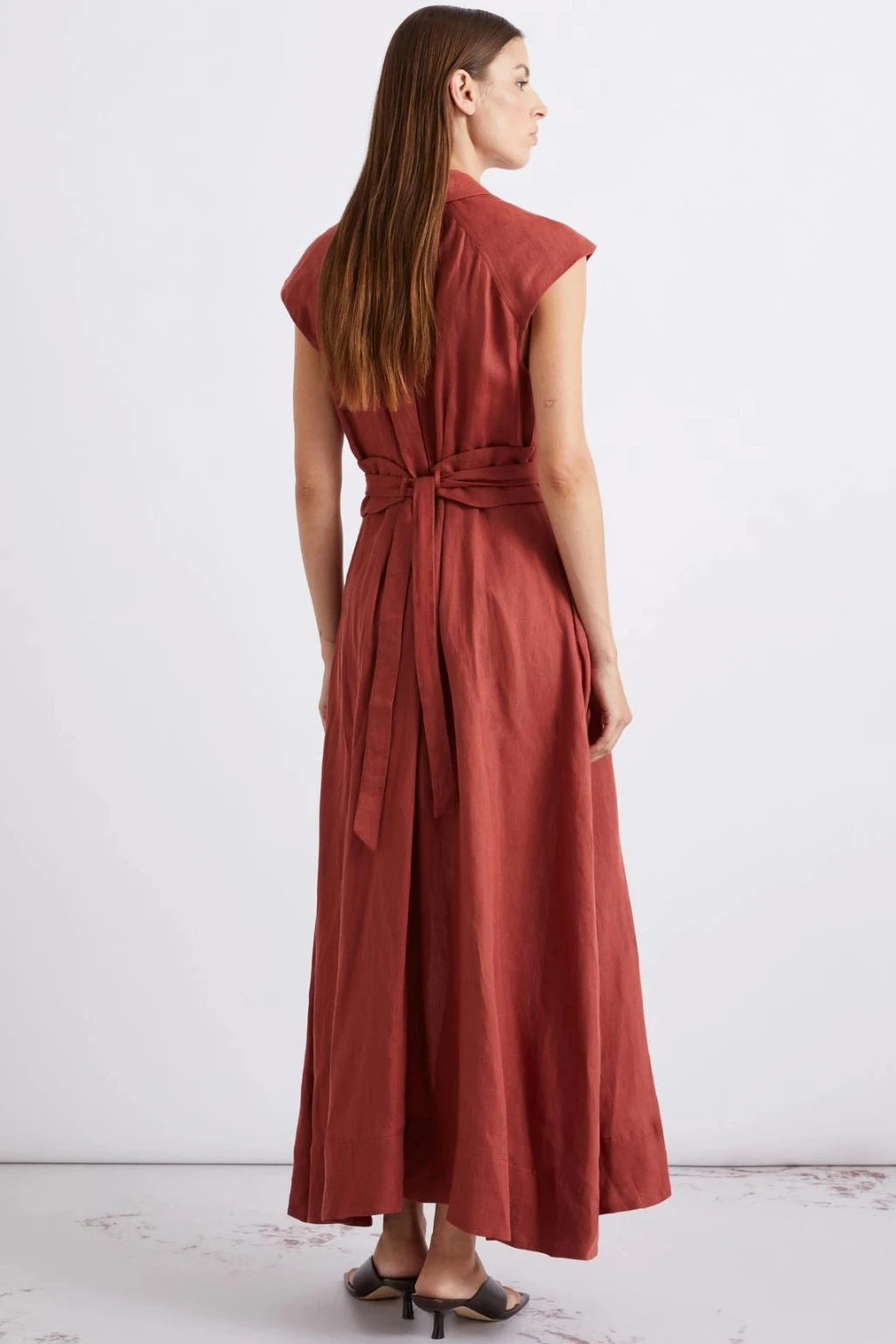 Back view of a woman wearing a dark red midi dress