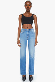 Woman wearing a pair of straight leg mid indigo wash denim