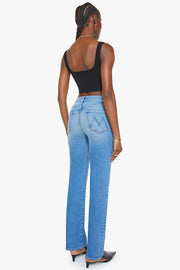 Back view of woman wearing a pair of straighter leg mid wash indigo jeans