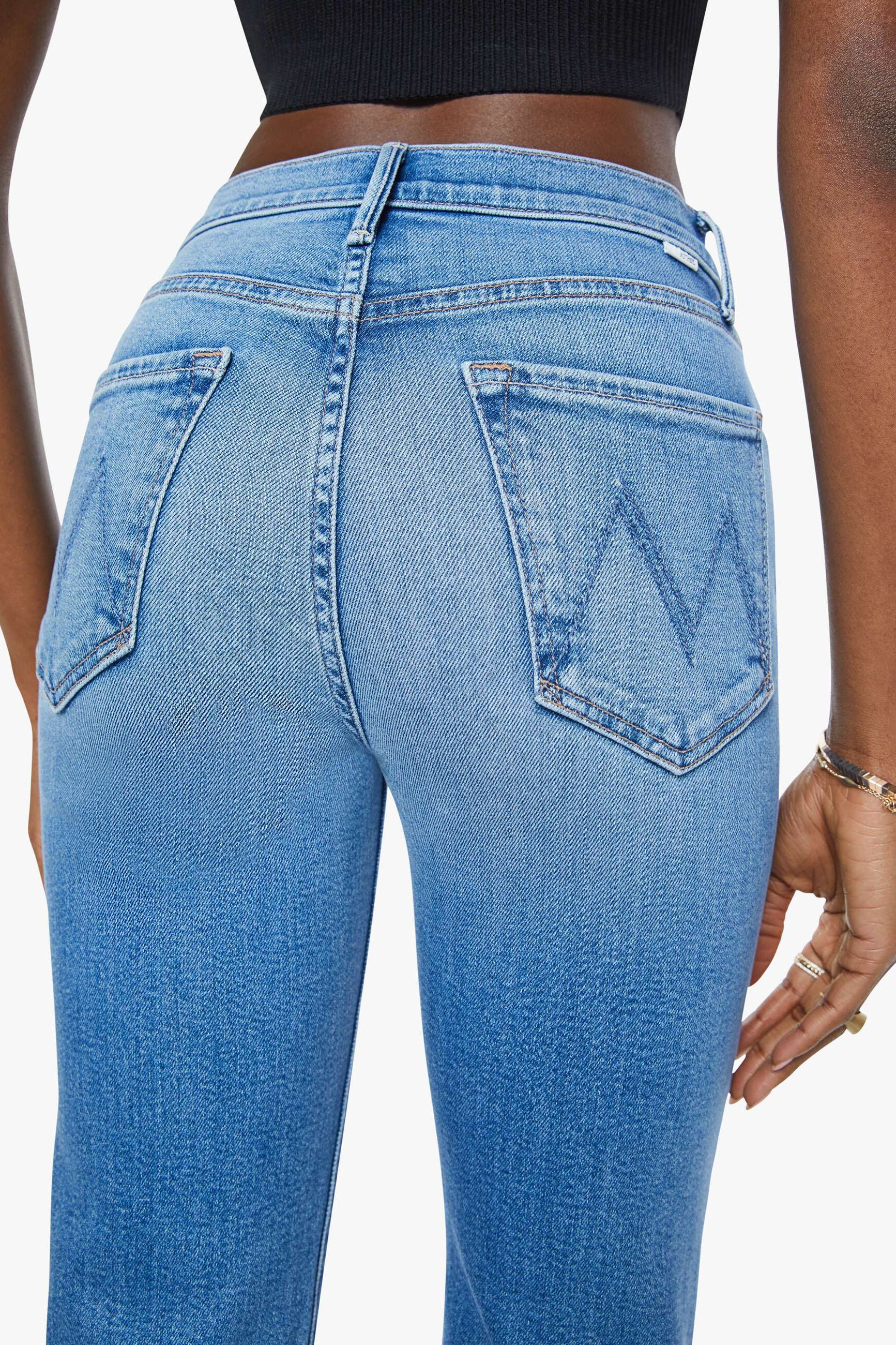 Close up of woman wearing a pair of mid indigo wash straight leg denim