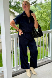 woman  wearing navy blue tie up satin pants 