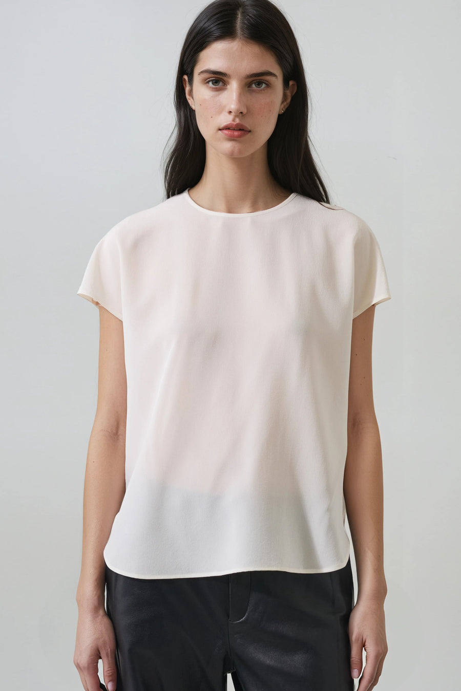 model wearing sheer cream t shirt with relaxed fit 