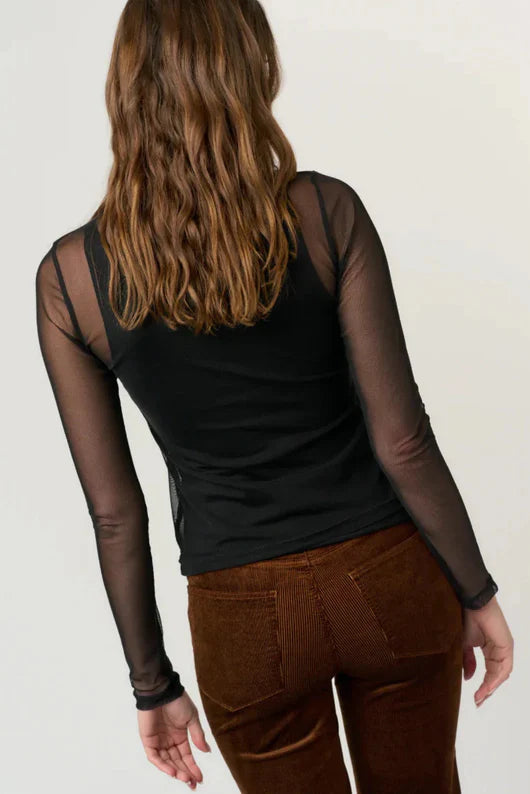 woman wearing a black mesh long sleeve with a tank top underneath