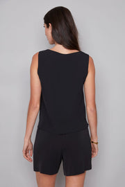 woman wearing sleeveless vegan silk black top