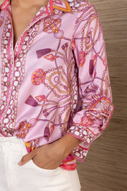 close-up of a pink silk button down with rouching on the sleeves