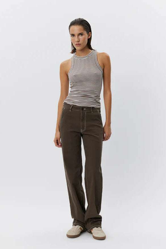 Woman wearing a brown and white striped sleeveless tank top with a fitted silhouette, front