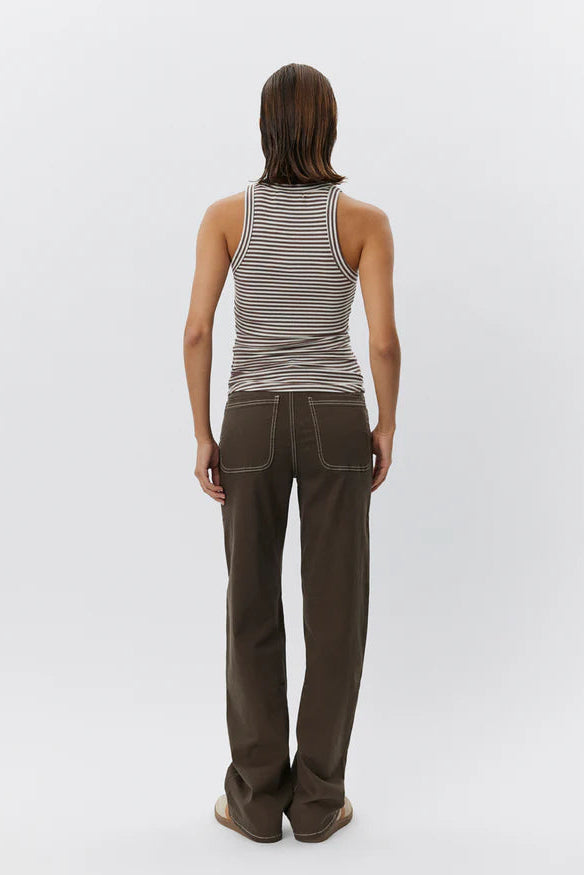 Woman wearing a brown and white striped sleeveless tank top with a fitted silhouette, back