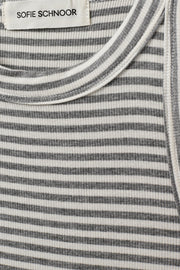 Woman wearing a grey and white striped sleeveless tank top with a fitted silhouette, fabric detail