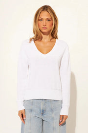 woman wearing a dove white long sleeve knit top