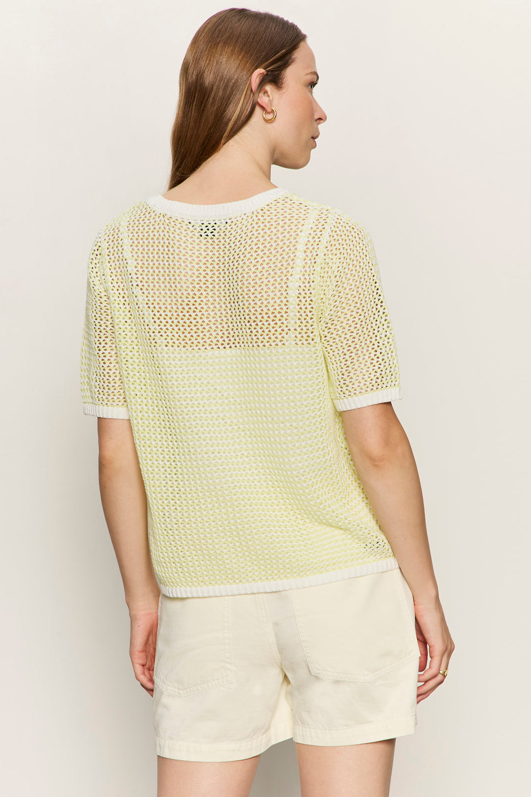 backview of light yellow open knit sweater