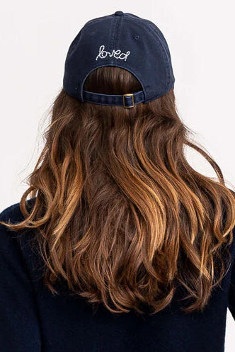 Navy blue baseball cap with a white heart 