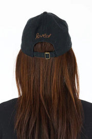 Black cap with 'love' embroidery on a white background