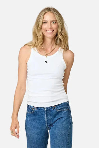 Women wearing white tank top with embroidered heart