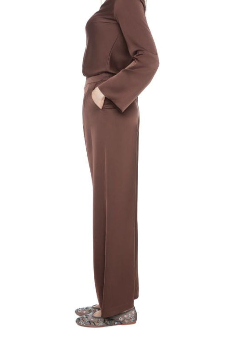 Woman wearing a brown satin set outfit on a white background